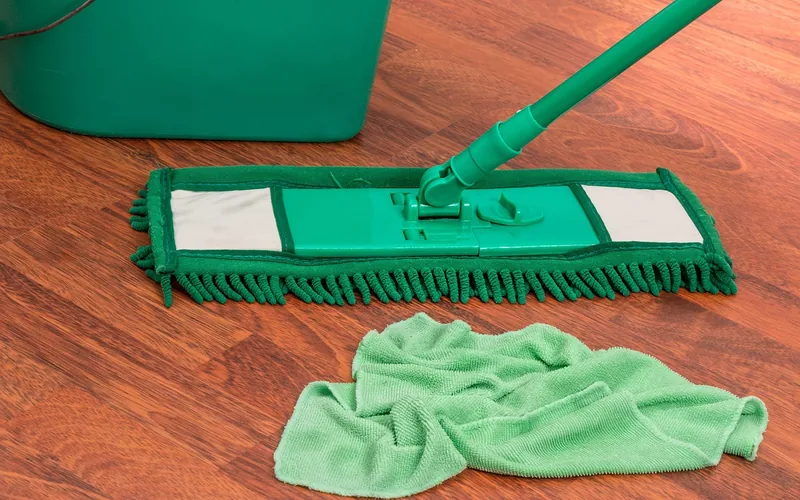 microfiber mop, bucket, and cleaning cloth staged on a hardwood floor microfiber mop, bucket, and cleaning cloth staged on a hardwood floor