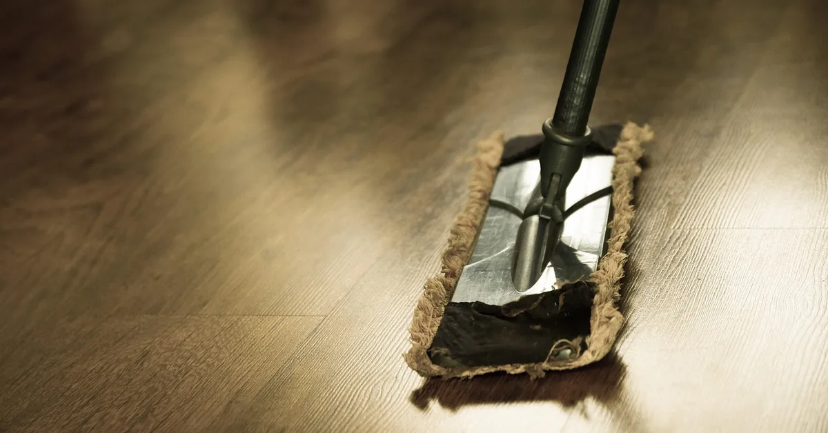 microfiber flat mop head cleaning a glossy hardwood floor