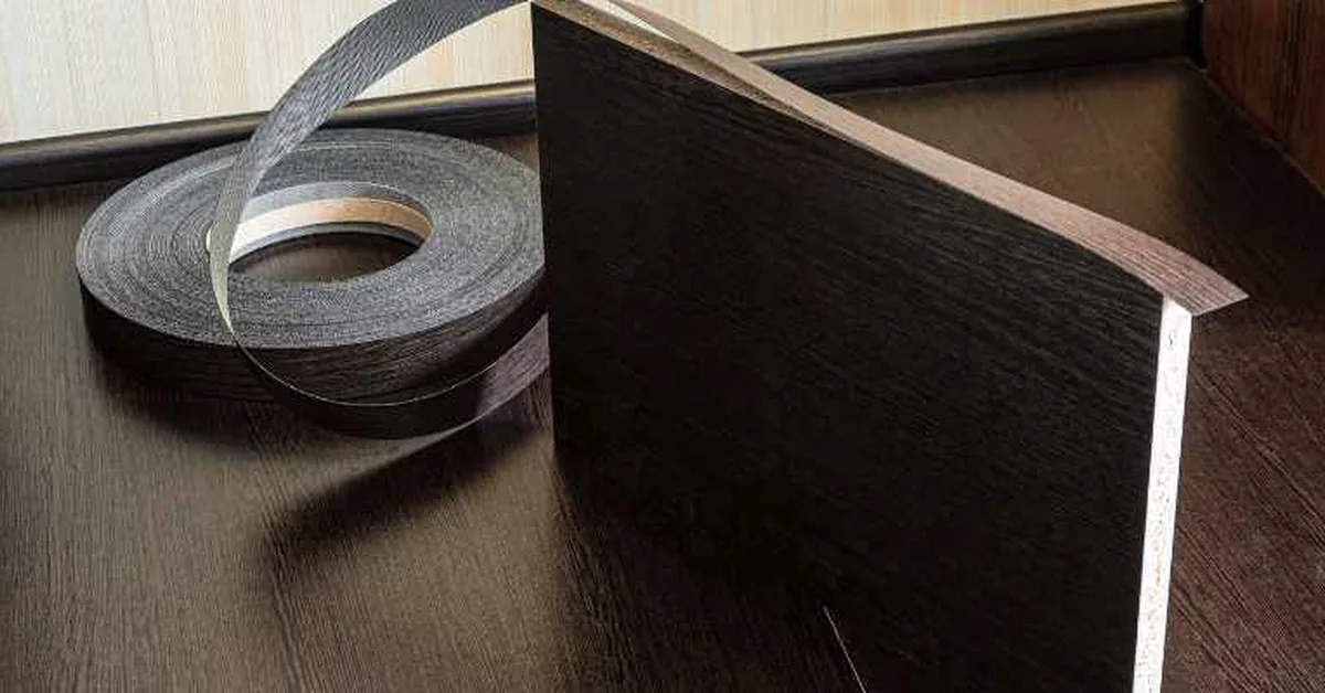 Melamine-coated particleboard sheet with matching edge banding tape, showing the thin resin surface layer