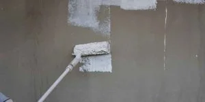 Exterior wall being coated with primer before an exterior-rated topcoat Exterior wall being coated with primer before an exterior-rated topcoat