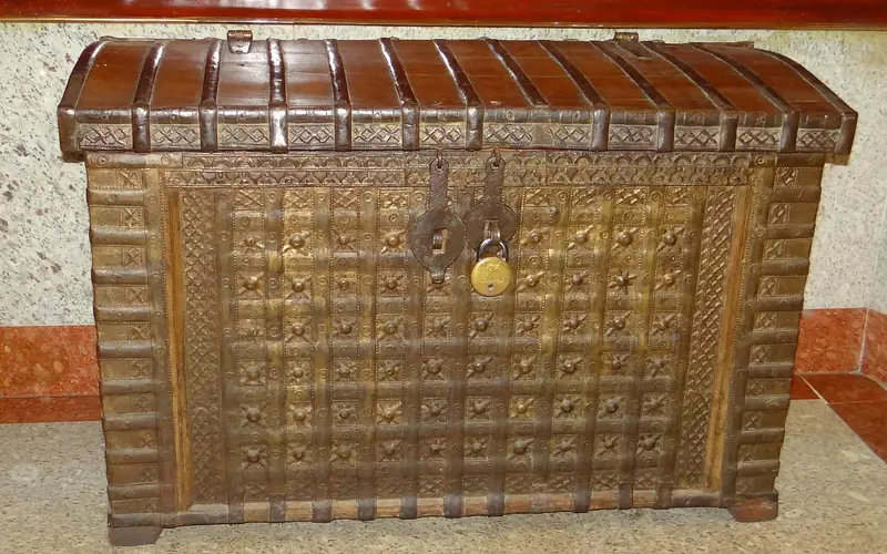close-up of an old wooden box corner showing aged brass hardware and worn wood grain close-up of an old wooden box corner showing aged brass hardware and worn wood grain