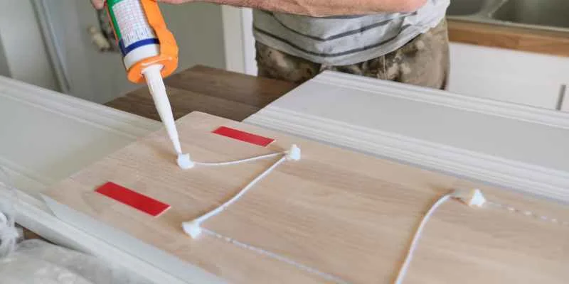 Applying wood glue to a furniture joint before clamping