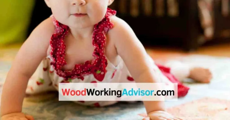 Baby crawling near a bed on a padded floor, illustrating fall risk onto hardwood
