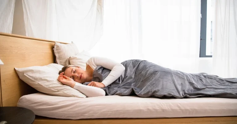 Solid wood bed frame supporting a mattress in a bedroom