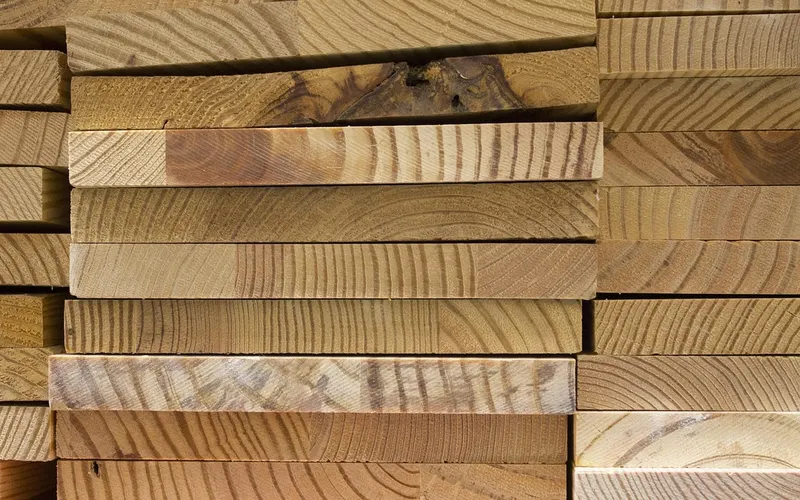 Stack of hardwood lumber boards showing grain patterns Stack of hardwood lumber boards showing grain patterns