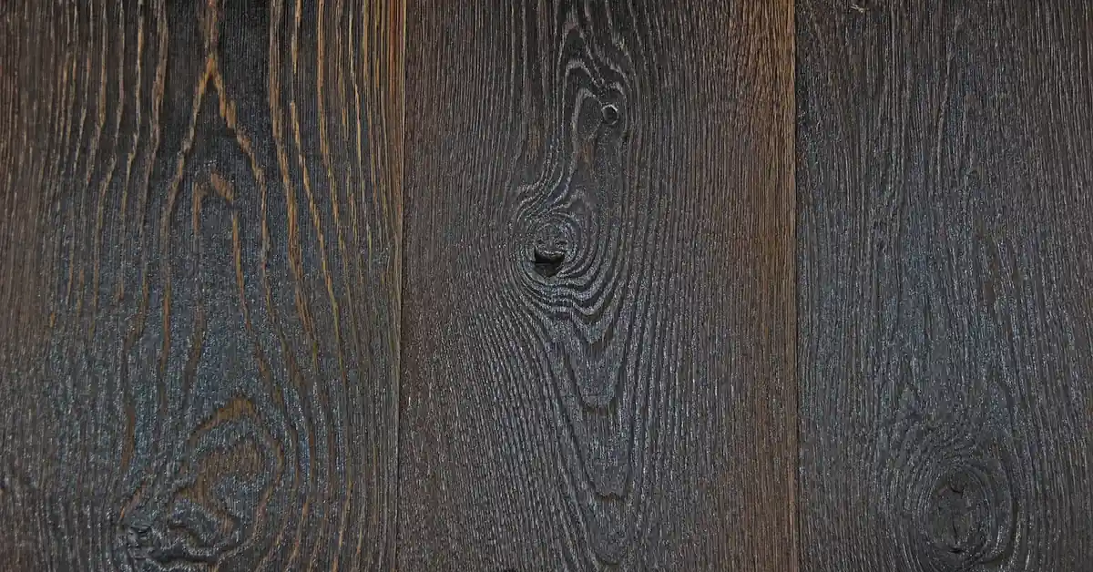 Dark ebonized oak hardwood flooring planks showing wood grain in a near-black stained finish