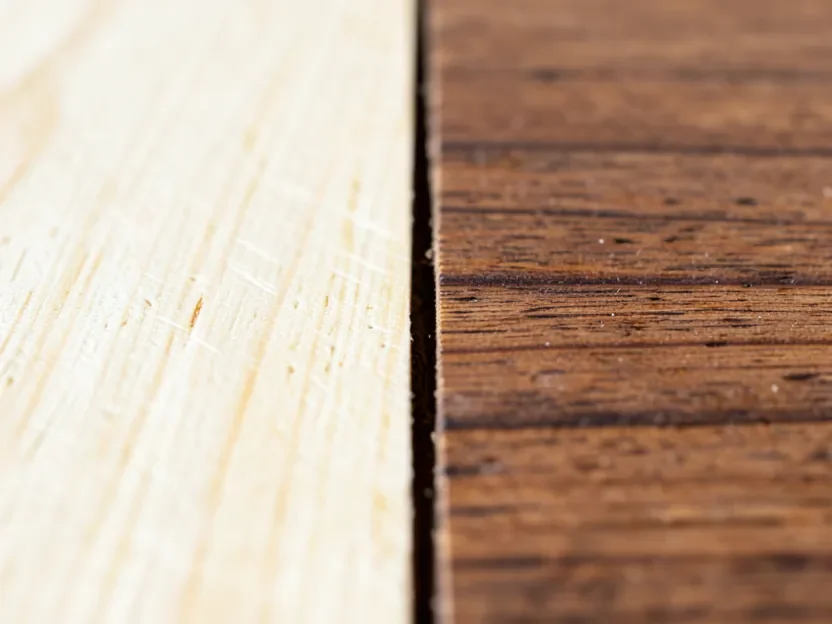 Wood board showing a bleached light section next to the natural darker wood color