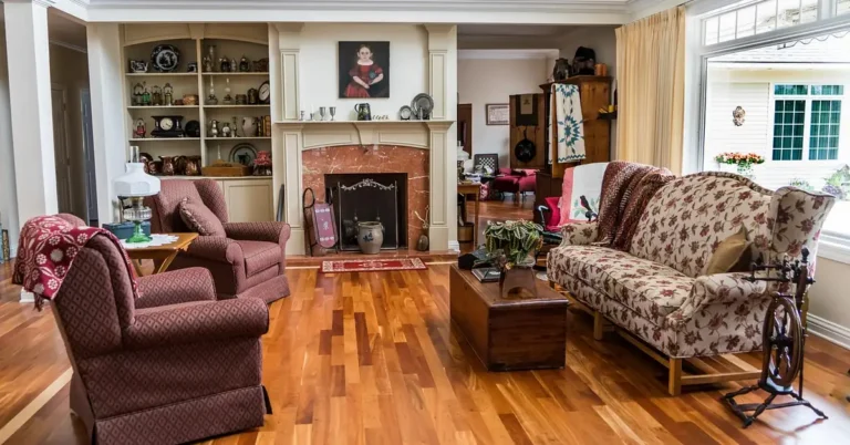 brown-toned wood floor in a cozy living room with upholstered armchairs and a fireplace