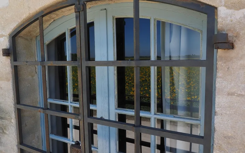 metal security bars mounted over a home window as a break-in deterrent