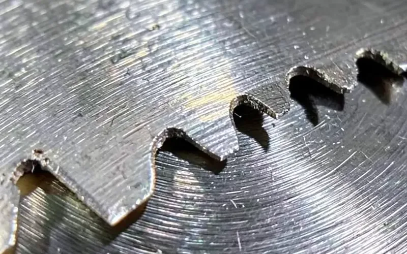 Close-up of carbide-tipped teeth on a metal cutting saw blade Close-up of carbide-tipped teeth on a metal cutting saw blade