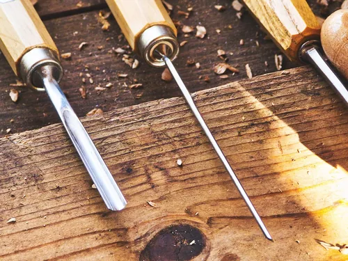 Carpenter using a hand plane on wood, tool relevant for interlocked-grain zebrawood