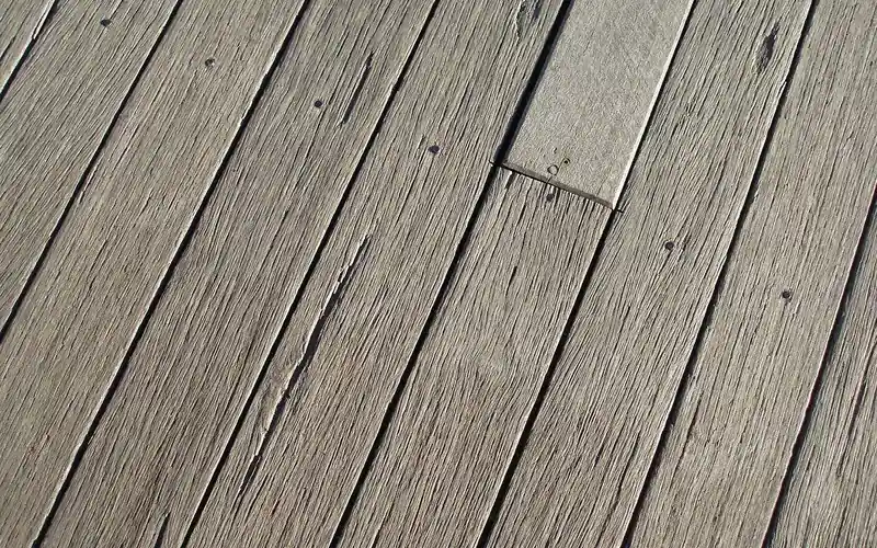 Close-up of cedar deck boards showing grain pattern before sealing