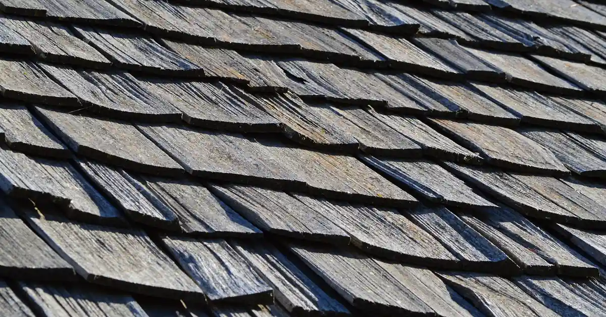 Weathered wood shake shingles showing natural gray patina and wood grain texture