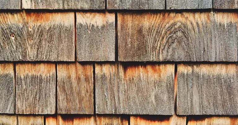 Weathered cedar shake shingle siding showing natural wood grain and color variation