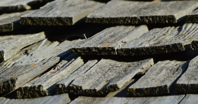 Close-up of hand-split wooden cedar shingles layered on a roof