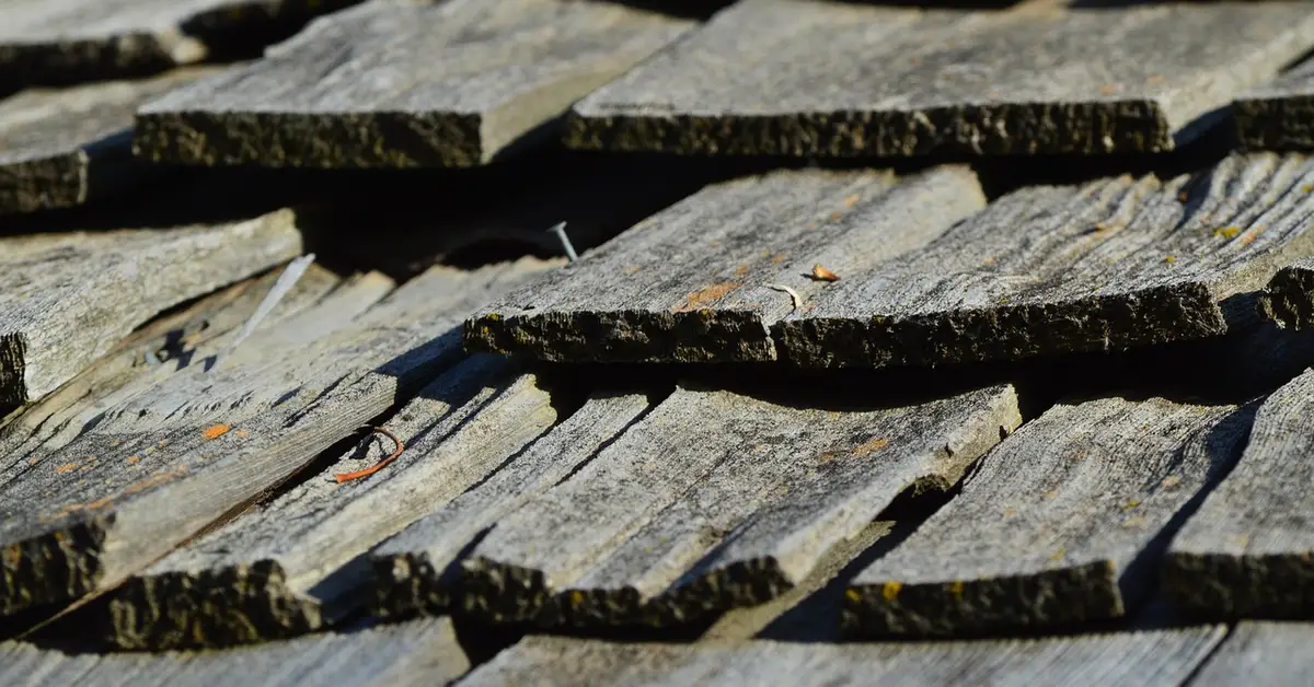 Close-up of hand-split wooden cedar shingles layered on a roof