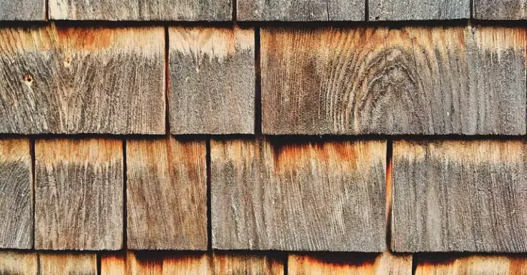 Weathered cedar wood shingles showing natural graying from UV and moisture exposure