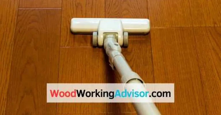 Vacuuming a cherry wood floor with a soft head before cleaning with a pH-neutral cleaner