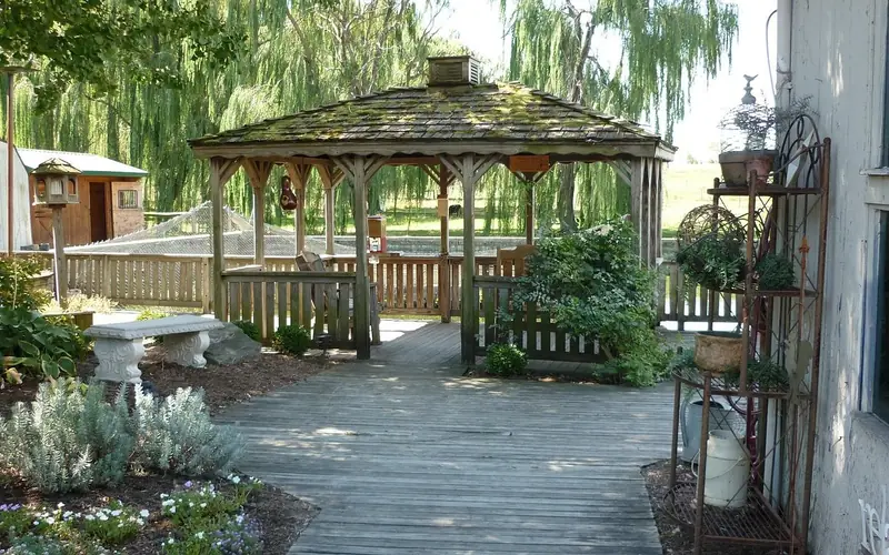 Backyard wooden deck walkway leading to a garden gazebo Backyard wooden deck walkway leading to a garden gazebo