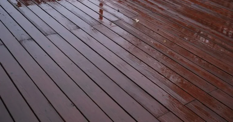 Wet composite decking boards glistening with rainwater beading on the surface