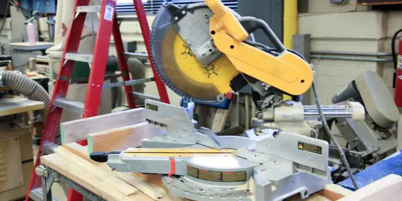 Compound miter saw set up on a workbench in a home workshop