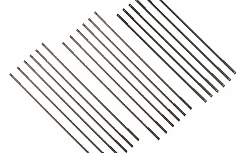 Assortment of coping saw blades in different TPI counts laid side by side for comparison