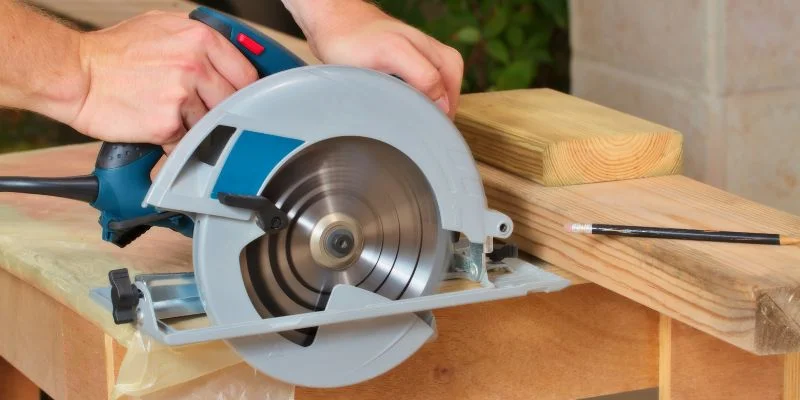 Corded circular saw cutting through a piece of lumber