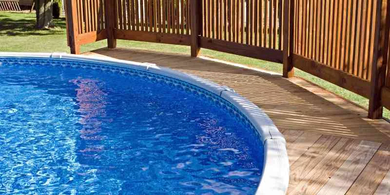 Curved wood deck built around a round above-ground pool
