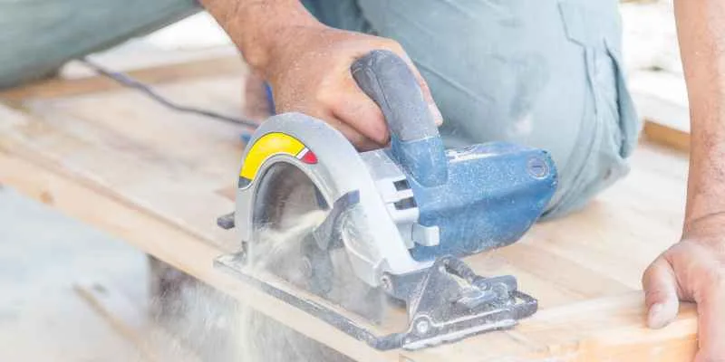 Guiding a circular saw along a marked line on an acrylic sheet