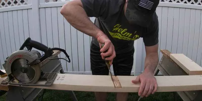 Woodworker chiseling the floor of a dado joint flat after making repeated circular saw passes