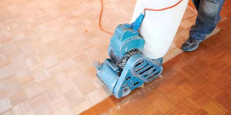 Drum sander refinishing a hardwood floor