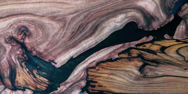 Clear epoxy river pour highlighting natural wood grain and burl figure