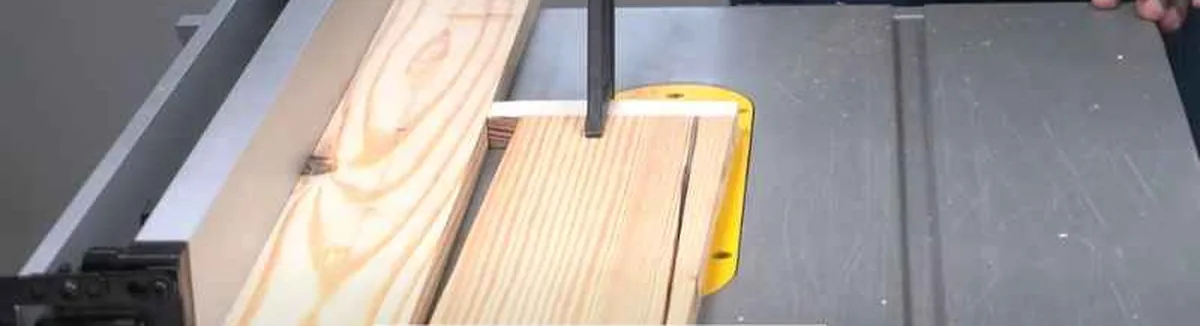 table saw ripping a beveled board with the riving knife visible behind the blade