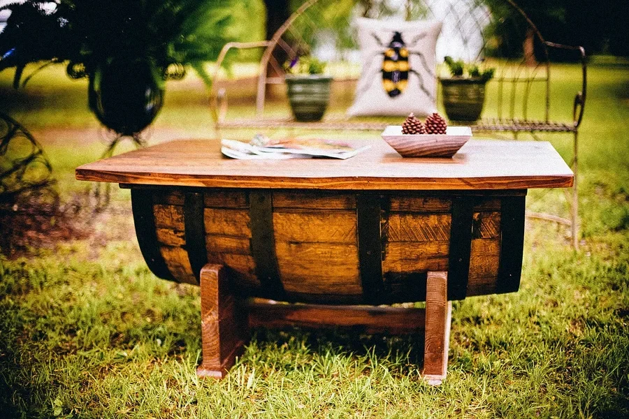 Finished wooden barrel coffee table sitting outdoors on grass