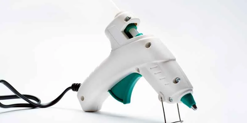 Hot glue gun with a selection of glue sticks