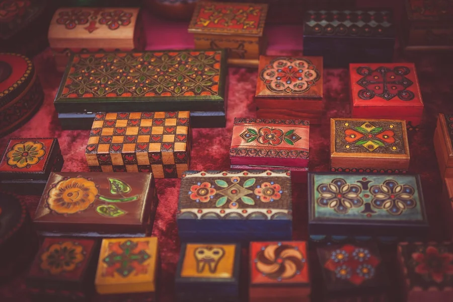 Hand-painted wooden craft boxes showing decorative acrylic paint pen work
