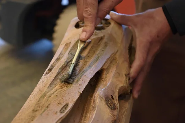 Hand-carving and shaping a wood joint with rasps and files