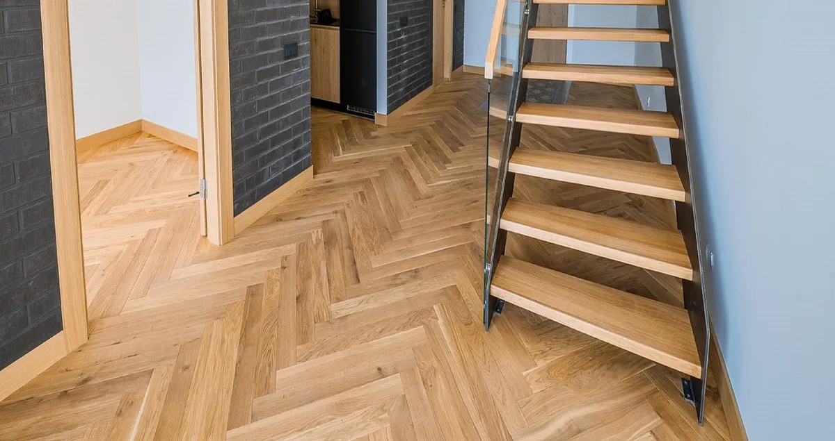 Finished herringbone hardwood floor in a hallway