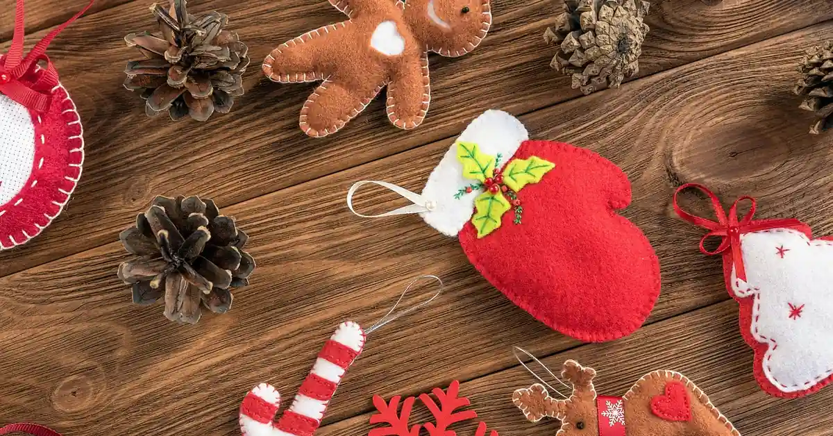 Felt craft pieces resting on a natural wood plank surface