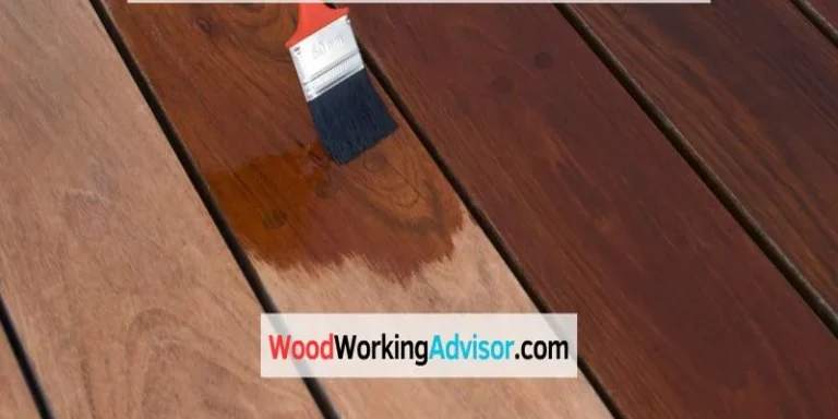 Applying stain to a deck board with a paintbrush