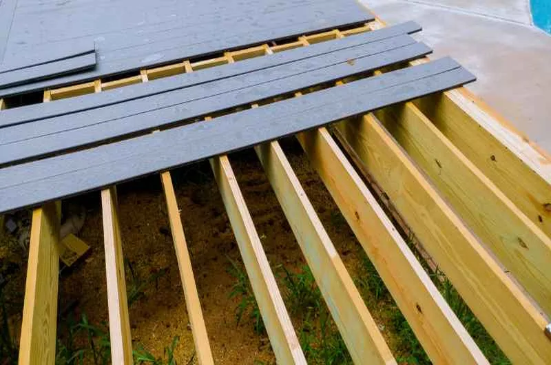 Installing new deck boards over wood joists after removing damaged sections