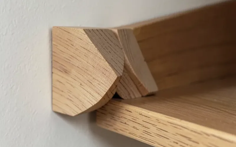 close-up of two interlocking 45 degree beveled wood French cleat strips