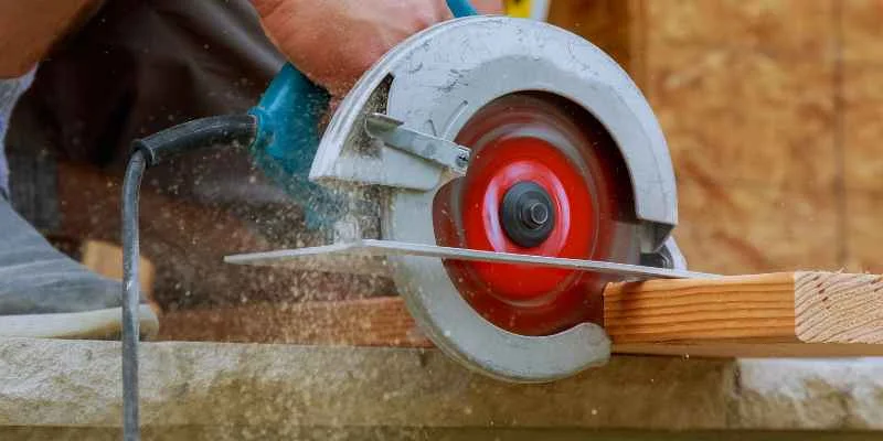 a carpenter choosing between two circular saw models