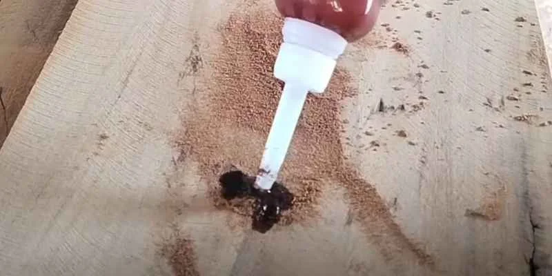 Loctite glue applied to a wood surface with sawdust