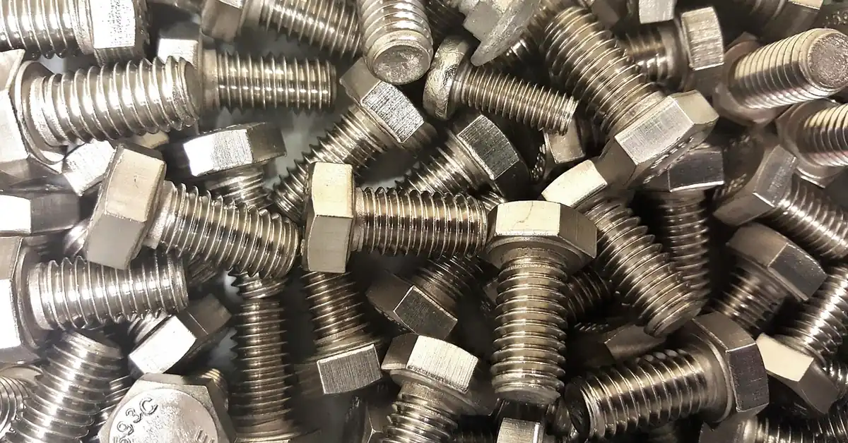 pile of steel hex bolts and nuts used for threadlocker adhesive application