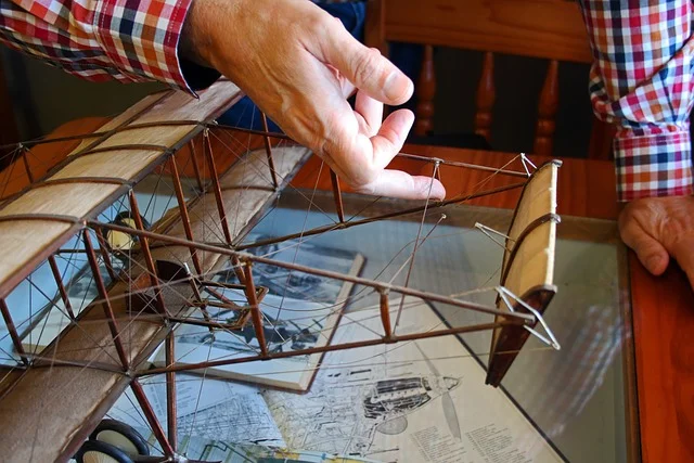 Hand-carved wooden biplane model showing the wing rib detailing typical of mahogany aircraft replicas
