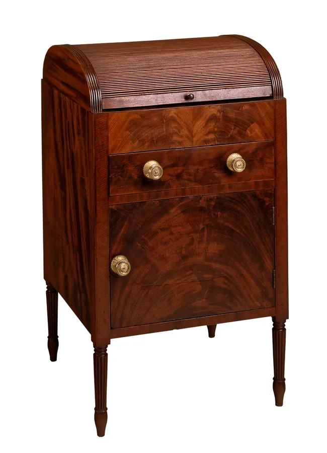 Mahogany roll-top cabinet with crotch-grain figure highlighted under a glossy film-forming finish Mahogany roll-top cabinet with crotch-grain figure highlighted under a glossy film-forming finish