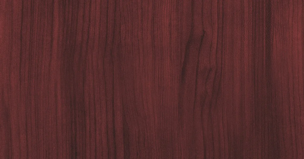 close-up of polished mahogany wood grain showing deep reddish-brown color and straight interlocked figure