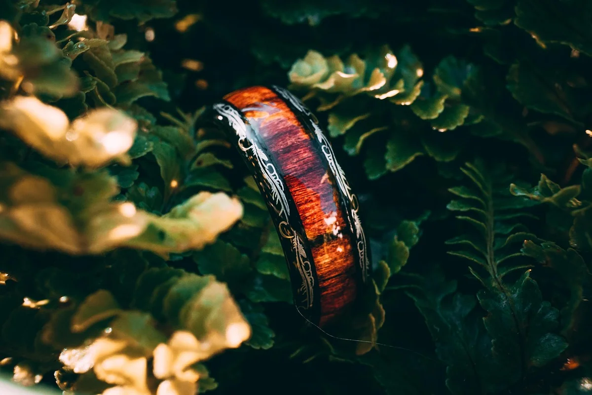 Reddish-brown wood ring with decorative inlay banding