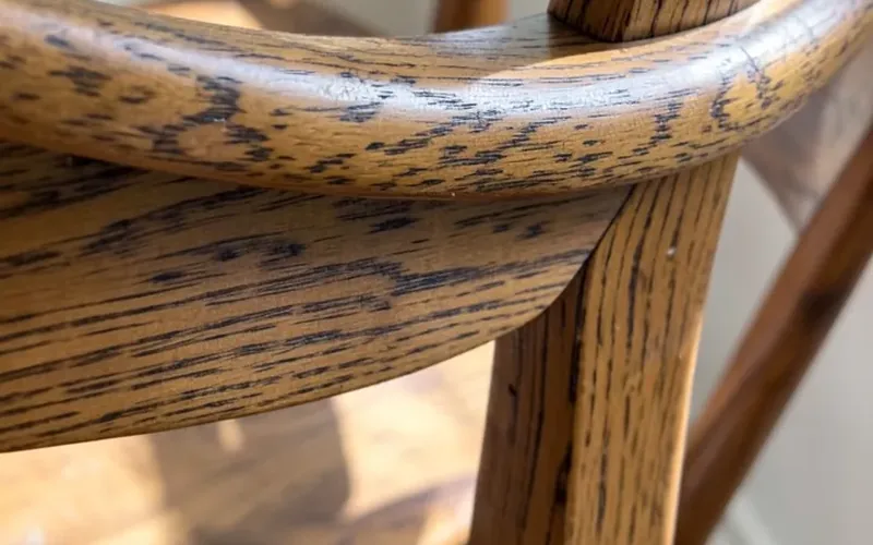 Sculpted continuous joint where a rocking chair arm curves into the back spindle